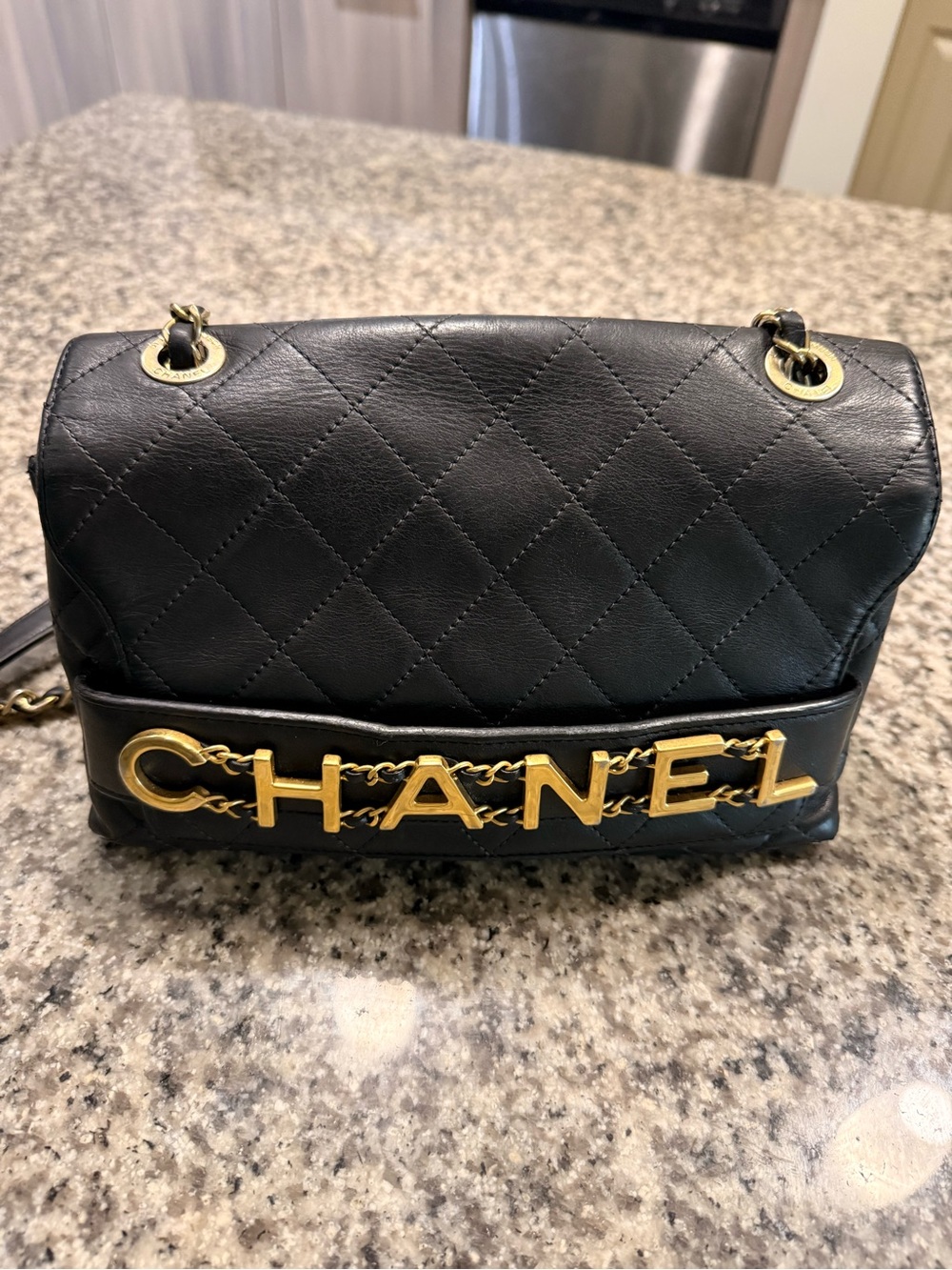 CHANEL Black Quilted Leather Shoulder Bag with Gold CHANEL Lettering